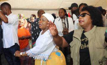 First Lady Dr Auxillia Mnangagwa and actress Patience Musa, popularly known as Mai Jilimbi, join the crowd in singing gospel songs during the funeral wake for actress Stella January in Mufakose